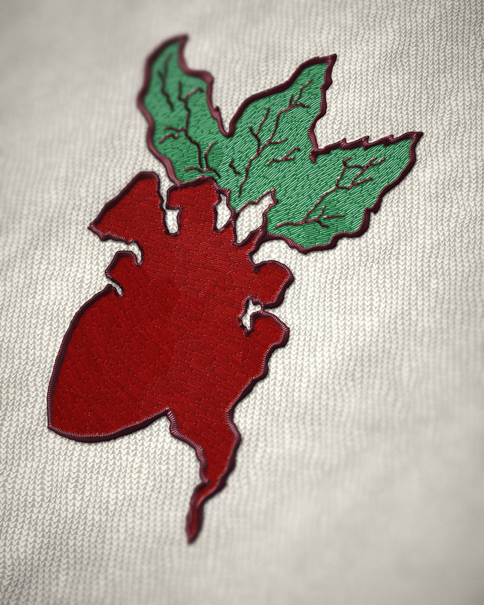 Embroidered beet shaped like an anatomical heart, red with green leaves, on white knit